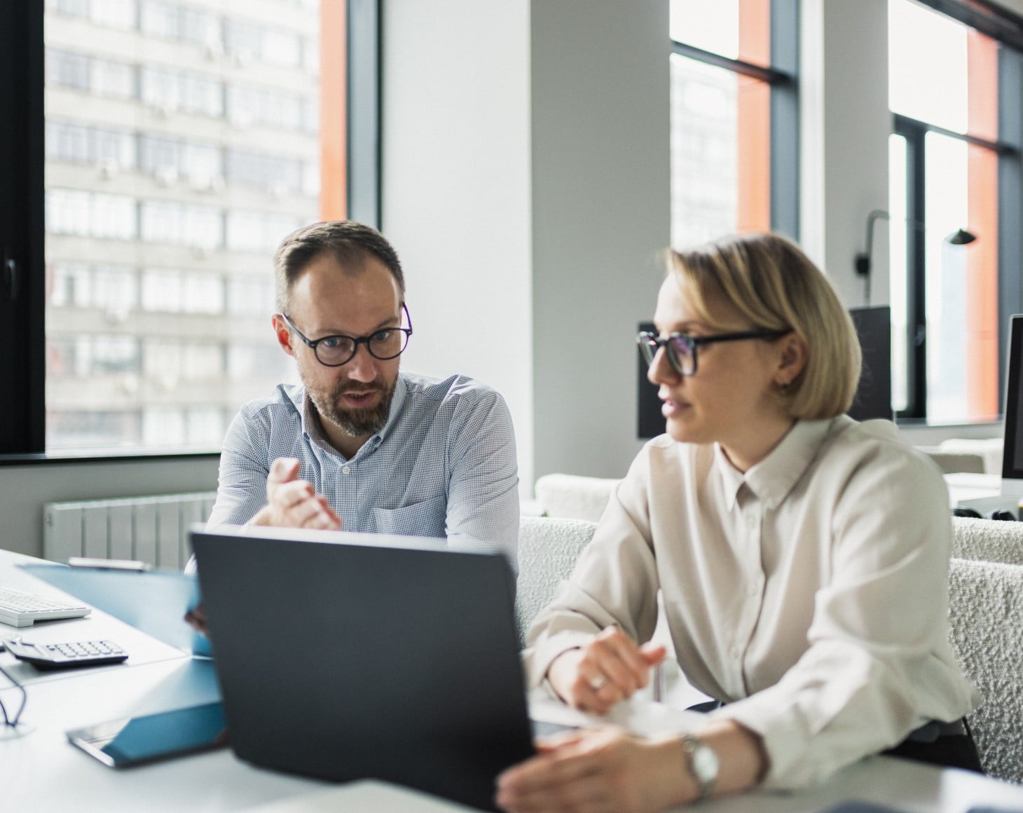 Two co-workers working at the office.